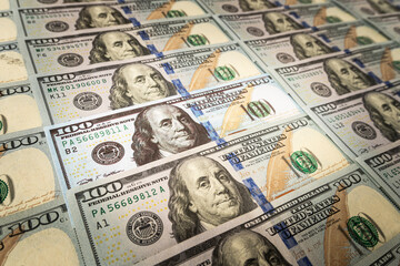 a fake bill among real money. US dollars on the background. verification of the authenticity of the American banknote. search for counterfeit bills