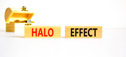 Halo effect and psychological symbol. Concept words Halo effect on wooden block. Beautiful white table white background. Wooden chest with coins. Business psychological Halo effect concept. Copy space
