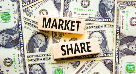 Market share symbol. Concept words Market share on beautiful wooden block. Beautiful background from dollar bills. Business and Market share concept. Copy space.