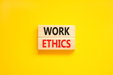 Work ethics symbol. Concept words Work ethics on beautiful wooden block. Beautiful yellow table yellow background. Business and Work ethics concept. Copy space.