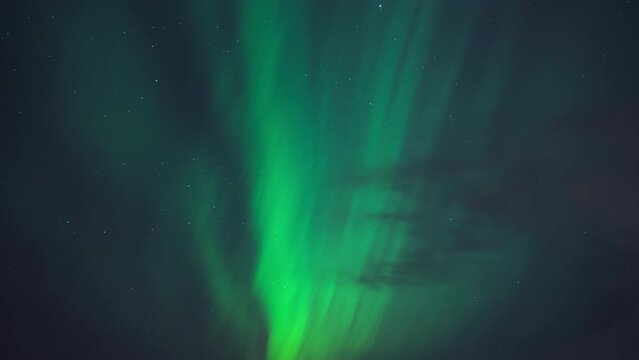 The night sky illuminated with colorful Northern Lights. Timelapse. 