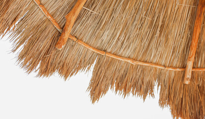 palapa sun roof beach umbrella by the beach symbolizes relaxation, shade, and protection. It...