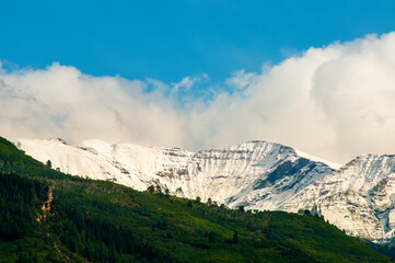 Obraz premium Snowy mountain peaks with clouds