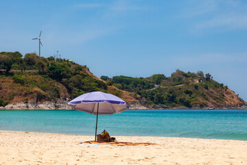 beautiful bright nai harn beach in thailand on phuket island with clear turquoise water in the sea, white sand with umbrella and blue sky. A popular tourist place in the hot countries of Asia.