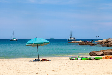 beautiful bright nai harn beach in thailand on phuket island with clear turquoise water in the sea, white sand with umbrella and blue sky. A popular tourist place in the hot countries of Asia.