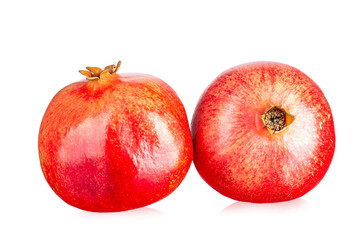 Two ripe pomegranates isolated on a white background.
