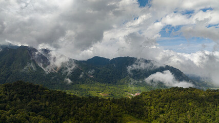 Fototapeta premium Aerial view of mountains with tropical forest and jungle. Sibayak active volcano. Sumatra, Indonesia.