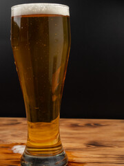 Glass of beer on a black background.