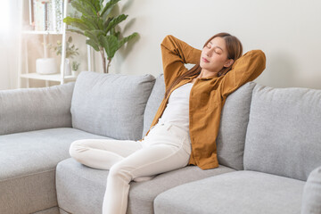 Young woman enjoying mind free moment relax and calm on the sofa at home.