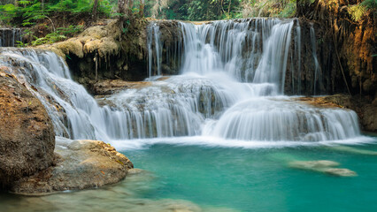 Fototapeta na wymiar Turquoise water flowing down the Kuan si falls near Luang Prabang - Laos