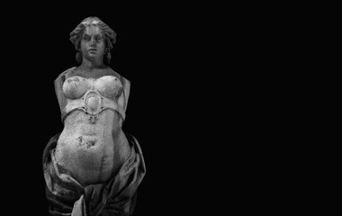 Fototapeta na wymiar The goddess of love in Greek mythology, Aphrodite (Venus in Roman mythology) Fragment of ancient statue against black background. Copy space.