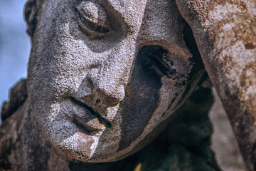 Sad eyes of beautiful angel. Fragment of ancient statue. Death, pain and end of life concept. Horizontal image.