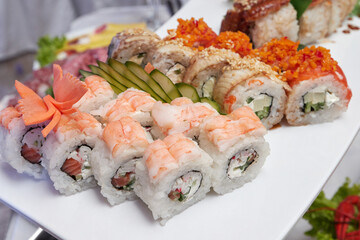 Sushi roll (Philadelphia) with salmon, smoked eel, avocado, cream cheese. Sushi menu. Japanese food.