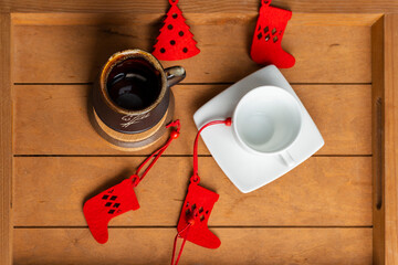 Coffee and tea cups on a wooden table with christmas decorations. flat lay. top view.