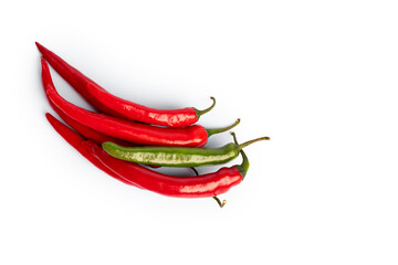 Composition of red and green peppers, one stand out. Isolated on white background. Flat lay, top view.