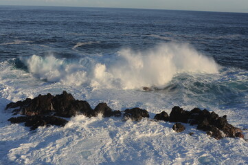 Big and strong waves breaking and crushing on the volcanic rocks on the Atlantic Ocean on coastline and seashore of Madeira Island, Portugal, Europe