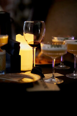 Glasses with Alcohol are on the table at the party. Glasses with alcohol on the table against the background of candles