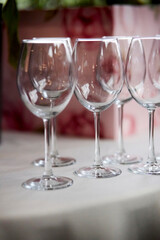 empty wine glasses on the table. empty glasses in a restaurant. empty wine glasses on a table in a restaurant, soft focus, blurred background. vertical photo orientation
