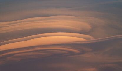 Background with detail of lenticular clouds at sunset