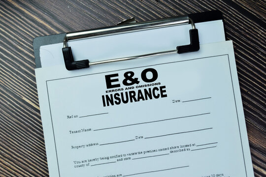 Concept of E&O - Errors and Omissions Insurance write on document isolated on Wooden Table.