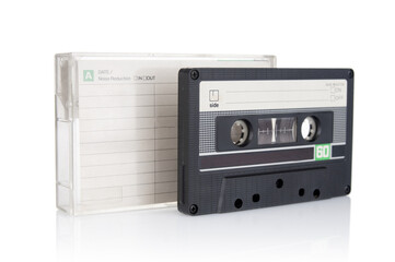 Old vintage audio compact cassette and plastic box  close up isolated on white background
