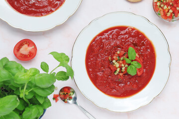Plates with traditional gazpacho tomato soup