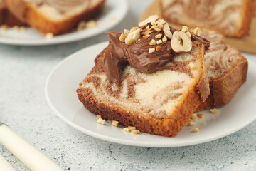 Fototapeta na wymiar A piece of marble biscuit with chocolate cream and nuts