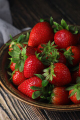 A bowl with ripe bright strawberry in rustic style