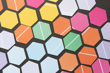 six sided polygon or hexagon shapes cut from scrapbook paper with distinct 