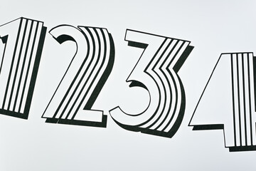 fancy type machine cut paper numbers 1234 on a light surface