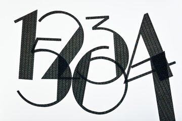 fancy type machine cut paper numbers 1, 2, 3, 4, 5, 6 on a light surface