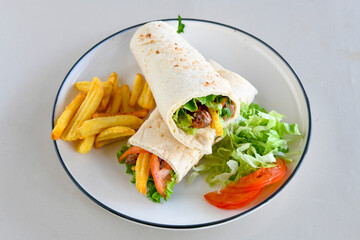 Lavash doner kebab ( zurna doner durum )  or shawarma sliced in plate isolated. 