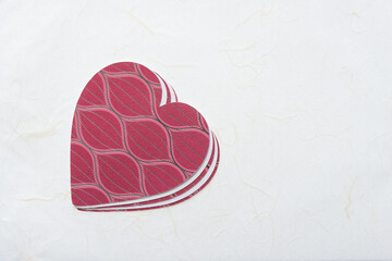 pile of hearts on a textured paper surface