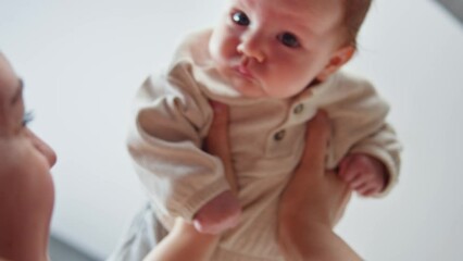 Grandmother holding her granddaughter close, comfort with pacifier. Intimate moment filled with warmth love and tenderness. Comfort and security is essential for healthy family.