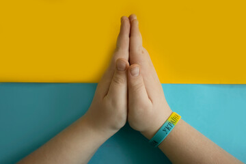 Children's hands on a colored background