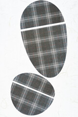 scrapbook paper machine cut shapes (mostly ovoids) on a light background - gray plaid