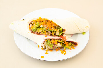 Cig kofte (raw meatball) with lettuce, tomato, pickle and lemon, hot Chee kofta. Turkish local raw food concept.Table scene of assorted take out or delivery foods. Doritoslu cig kofte durum.