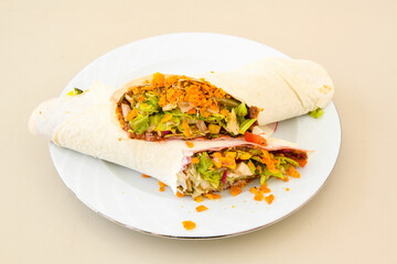 Cig kofte (raw meatball) with lettuce, tomato, pickle and lemon, hot Chee kofta. Turkish local raw food concept.Table scene of assorted take out or delivery foods. Doritoslu cig kofte durum.