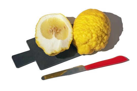 Yellow Citron ( Citrus medica, cedrate ) on cutting board isolated on white