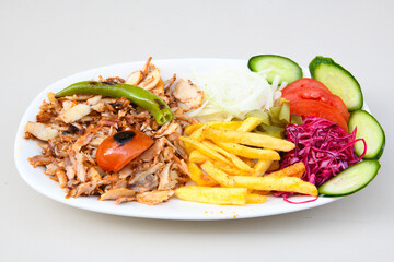 Turkish and Arabic Traditional Ramadan doner kebab with tasty tomato sauce and rice or turkish pilav in white plate on wood table background. ( Pilav ustu doner)