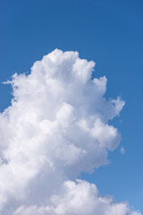 Towering cumulus white clouds in clear blue sky background