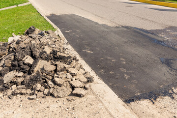 View of a freshly repaired section of paved road.