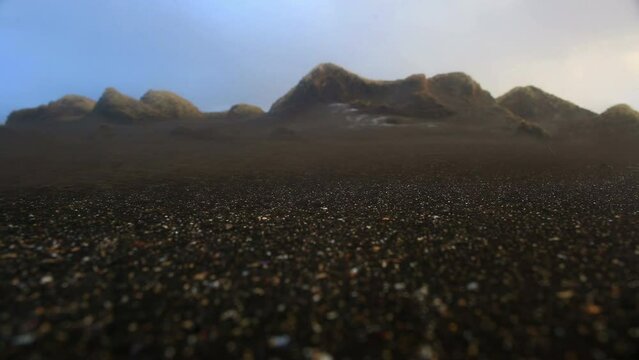 Sand carried by wind swirling accross a beach, Sandvik, Iceland
