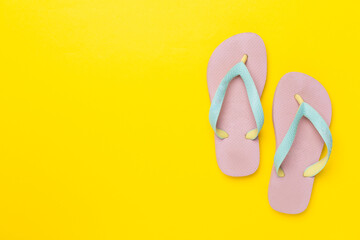 Bright flip flops on color background, top view