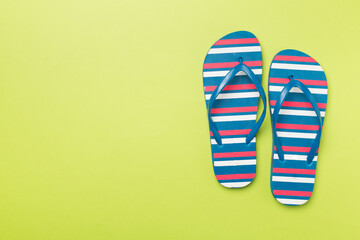 Bright flip flops on color background, top view