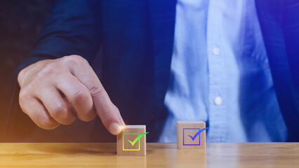 Hand choose wooden cube block with check mark, Quality Assurance Control Standards, Shows the sign of top service Quality assurance, Guarantee, Standards, ISO certification 