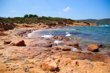 Rocky coastline by the beach of La Finosa in the bay of Porto Istana on the Costa Smeralda ("Emerald Coast") near Olbia in Sardinia, Italy