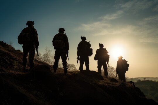 Silhouette of a group of army soldiers. Soldiers in war zone.