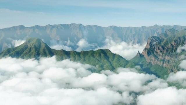 Timelapse sequence of tradewind clouds moving in front of the Pico Bejenado to the left and La Cumbrecita to the right with the Caldera de Taburiente in the background in La Palma. Seen from the top o