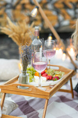 Romantic picnic with wine, cheese, lavender, strawberry
